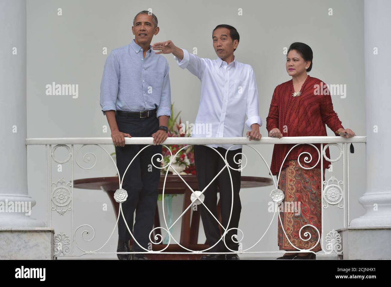 Indonesian President Joko Widodo Gestures Next To His Wife Iriana Widodo And Former U S President Barack