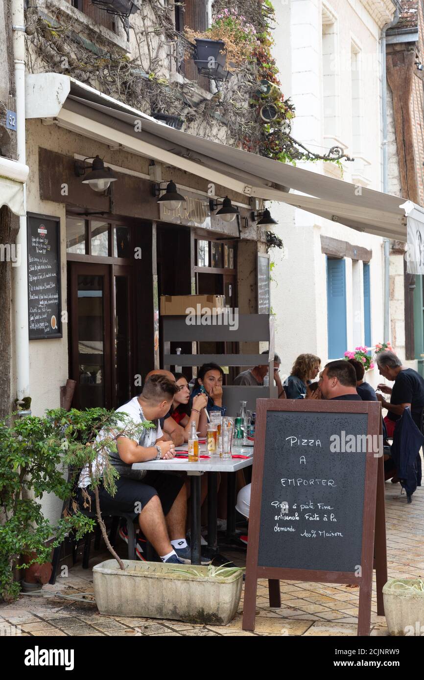 France restaurant; People eating and drinking at a pizzeria outdoors in