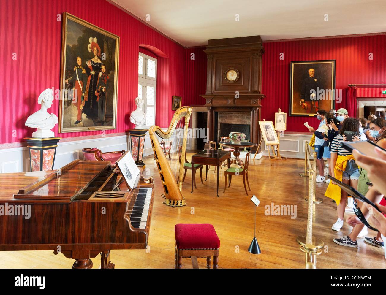 Tourists & visitors inside the Chateau D'Amboise, in the ornate Orleans Music room with musical instruments; Amboise France Europe Stock Photo