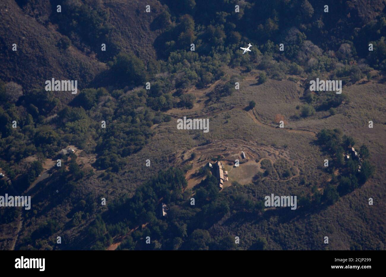 A Forestry Aircraft Flies Over A Home Near The Pfeiffer Fire In Big Sur California December
