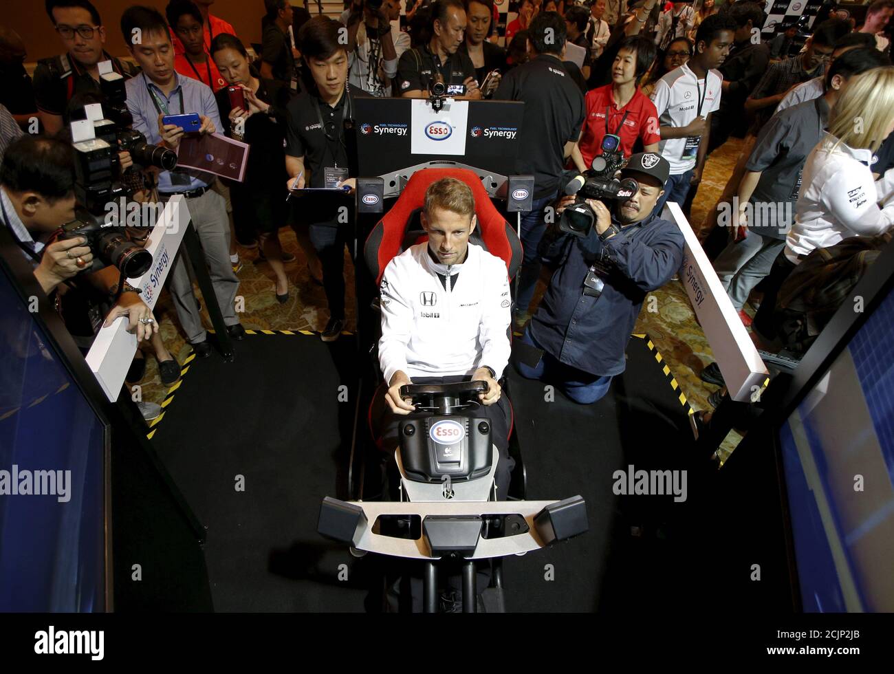 McLaren Formula One driver Jenson Button of Britain races in a virtual simulator during publicity events ahead of the Singapore F1 night race in Singapore September 16, 2015. The Singapore F1 Grand Prix night race takes place from September 18, 2015. REUTERS/Edgar Su Stock Photo