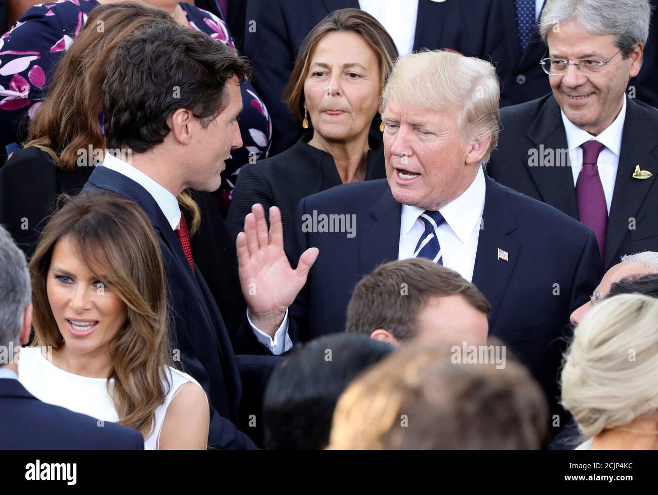 US President Donald Trump (C) talks with Canada's Prime Minister Justin  Trudeau (L) and his wife of Canada's Prime Minister Sophie Gregoire (Hidden  behind) as US First Lady Melania Trump (front L)