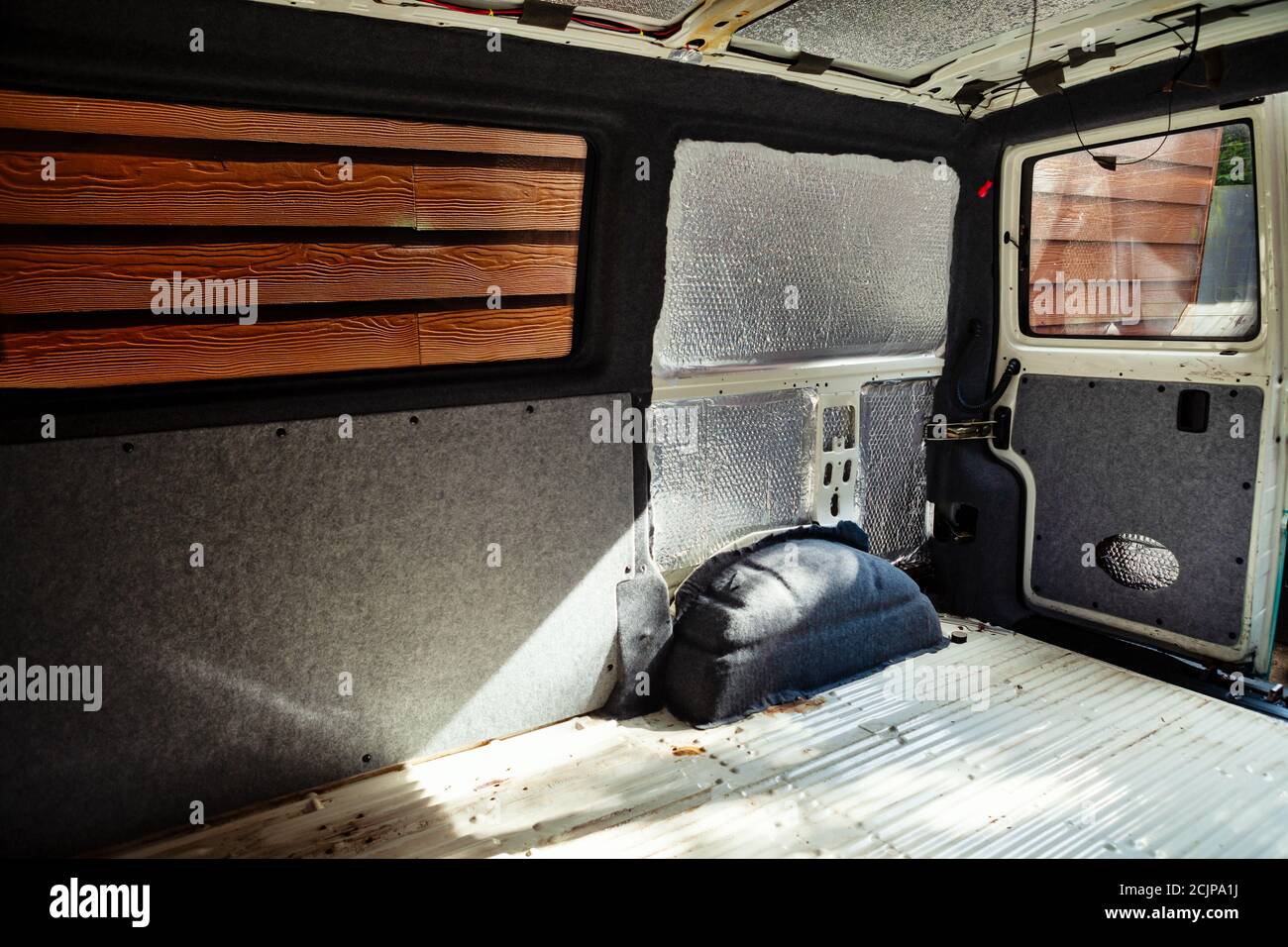 Conversion of a t4 van into a camper van.. Carpeting has been added to the metalwork and some of the carpeted panels have been added Stock Photo