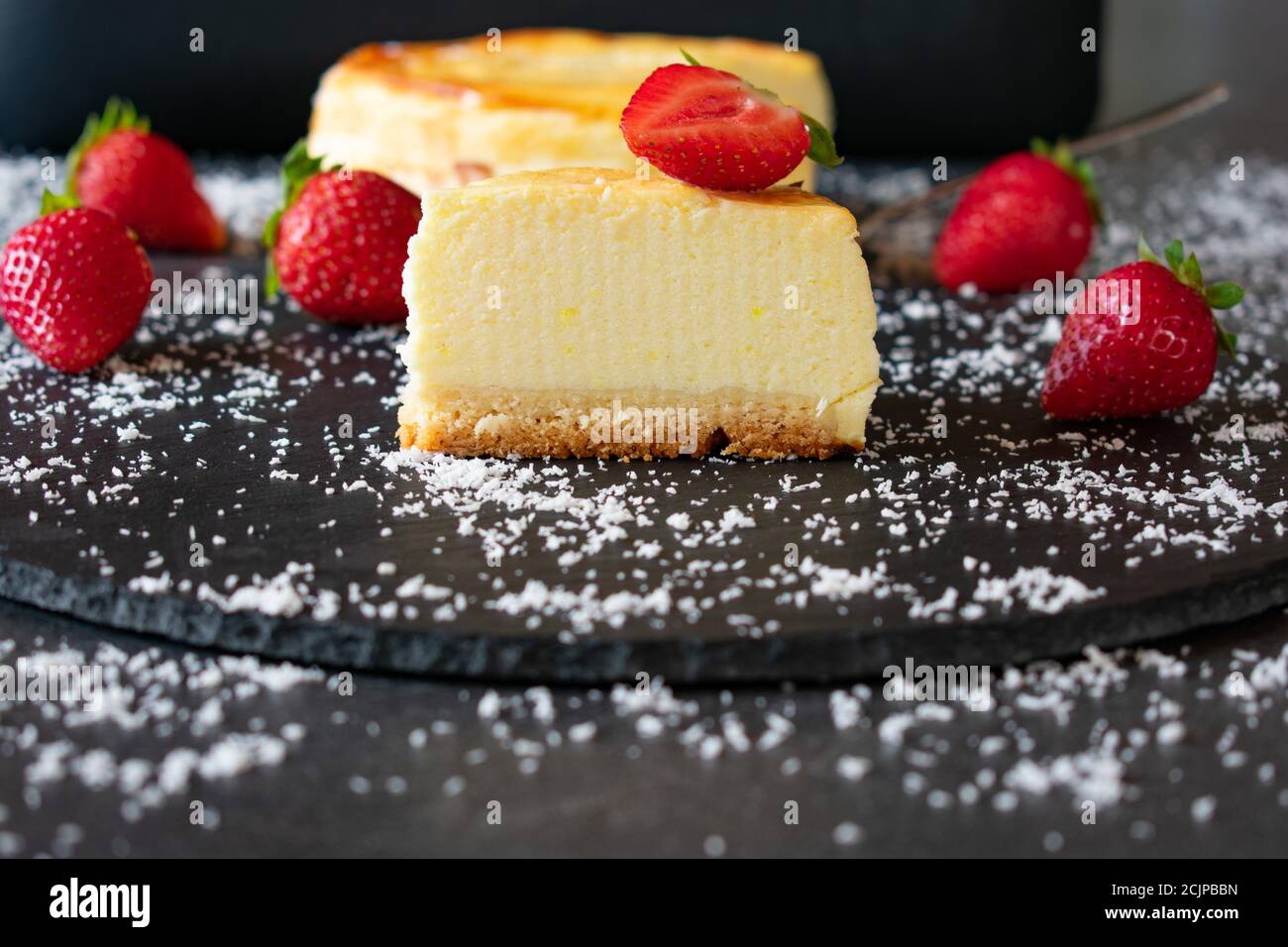 small cheesecake with strawberries on dark background Stock Photo