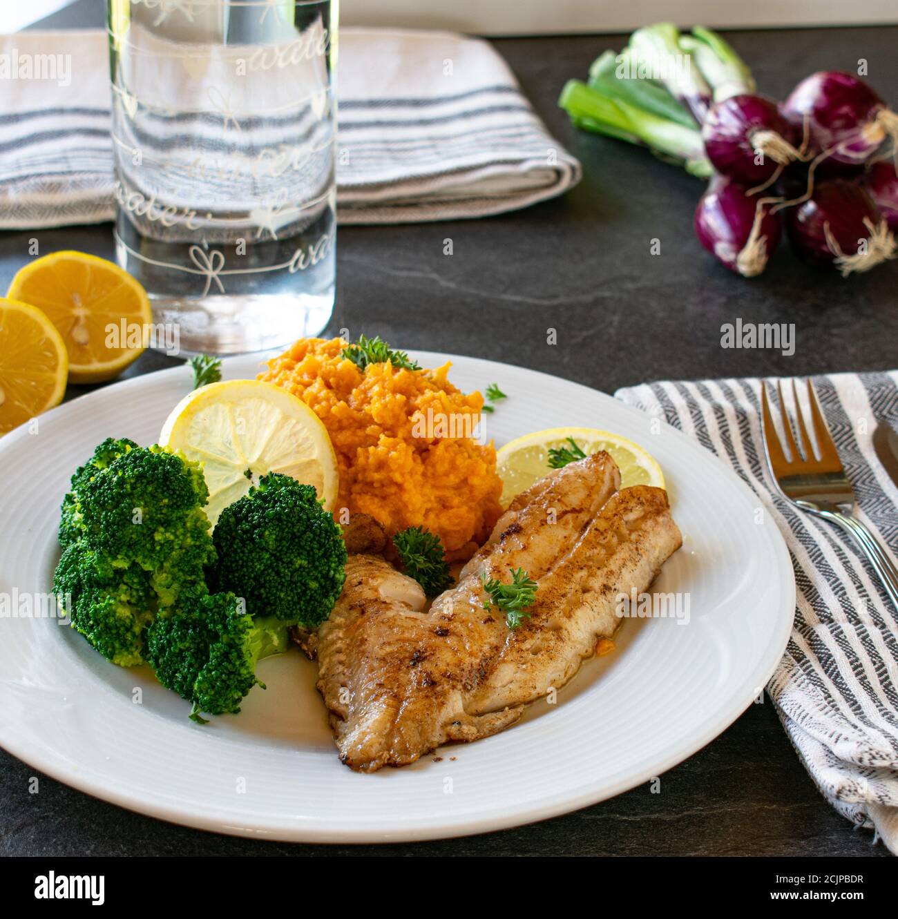 fish with sweet potatoes and broccoli served on a table - ready to eat ...