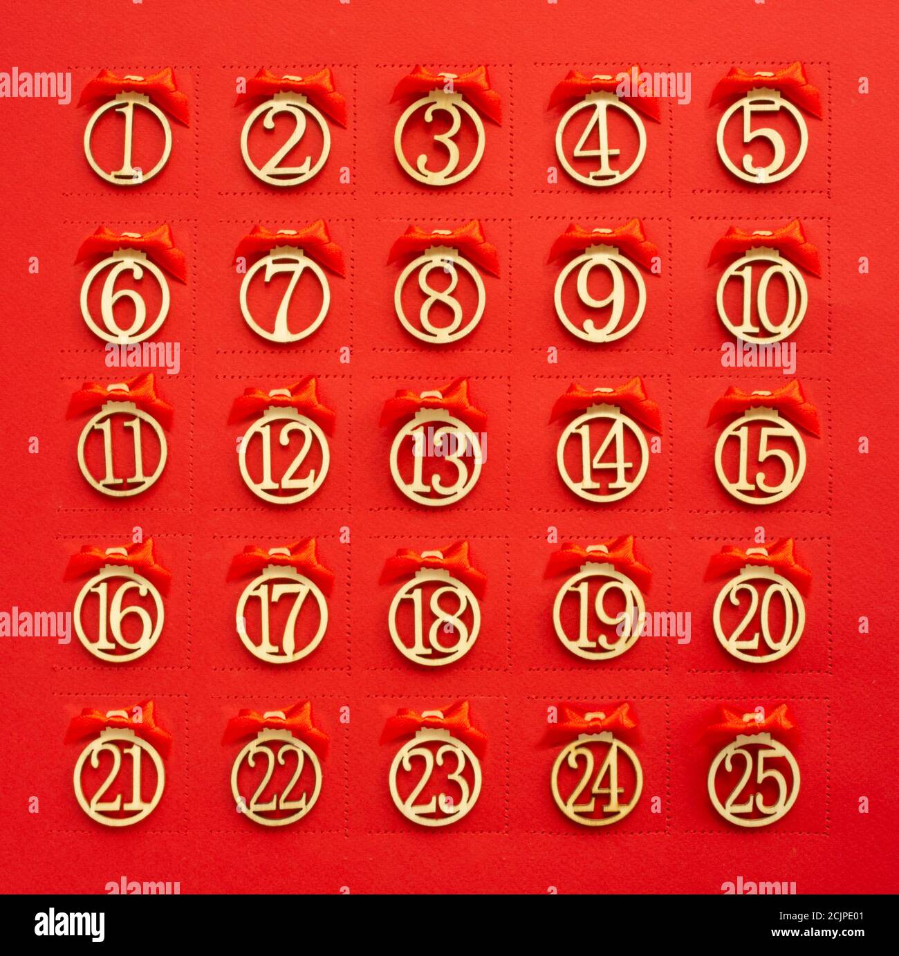 Abstract red Christmas advent calendar background with perforation windows in paper and day numbers and ribbon bows Stock Photo