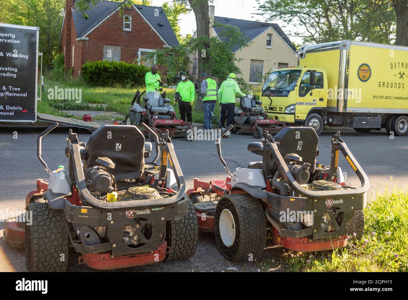 Detroit, Michigan - Workers from the Detroit Grounds Crew prepare to cut the grass on the grounds of the Burbank School, one of dozens of closed publi Stock Photo