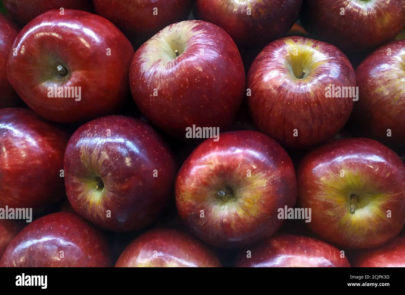 Background of raw red apple fruit groups in perspective, part of a