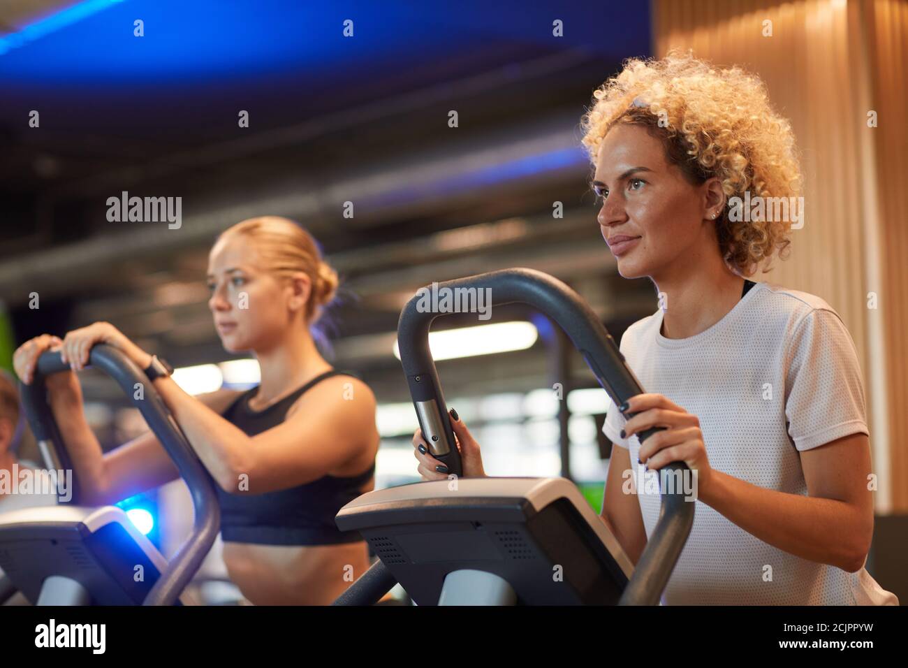 Two young women training on treadmills in modern gym Stock Photo - Alamy