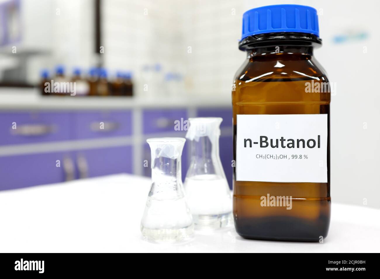 Selective focus of butanol or butyl alcohol in glass amber bottle inside a chemistry laboratory