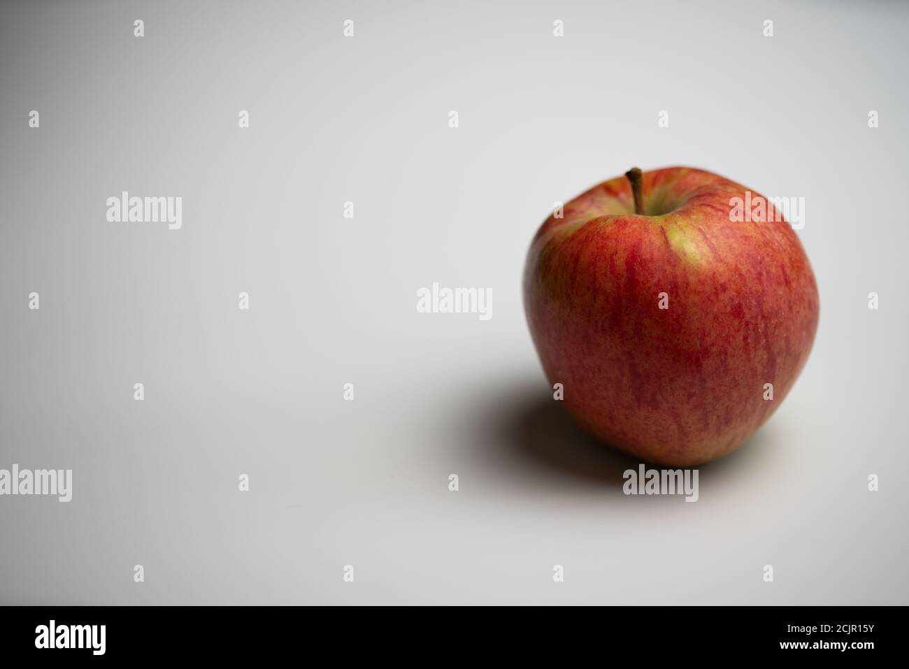 one red apple flat lay white background Stock Photo