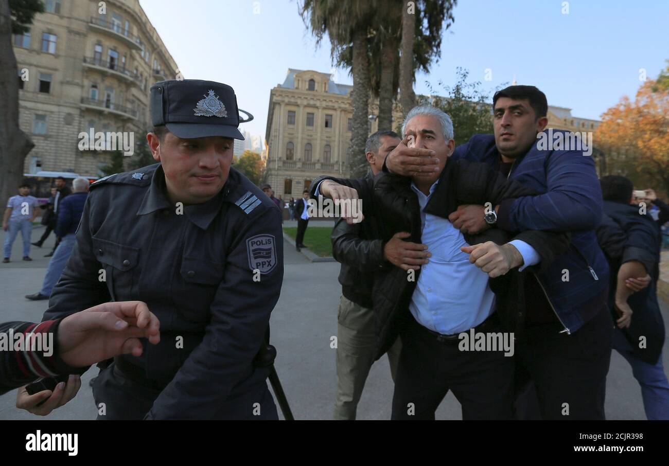 Unidentified men, who are presumably plain-clothes law enforcement officers, detain participants of an Azeri opposition rally to demand freedom of assembly in Baku, Azerbaijan November 12, 2019. REUTERS/Aziz Karimov Stock Photo