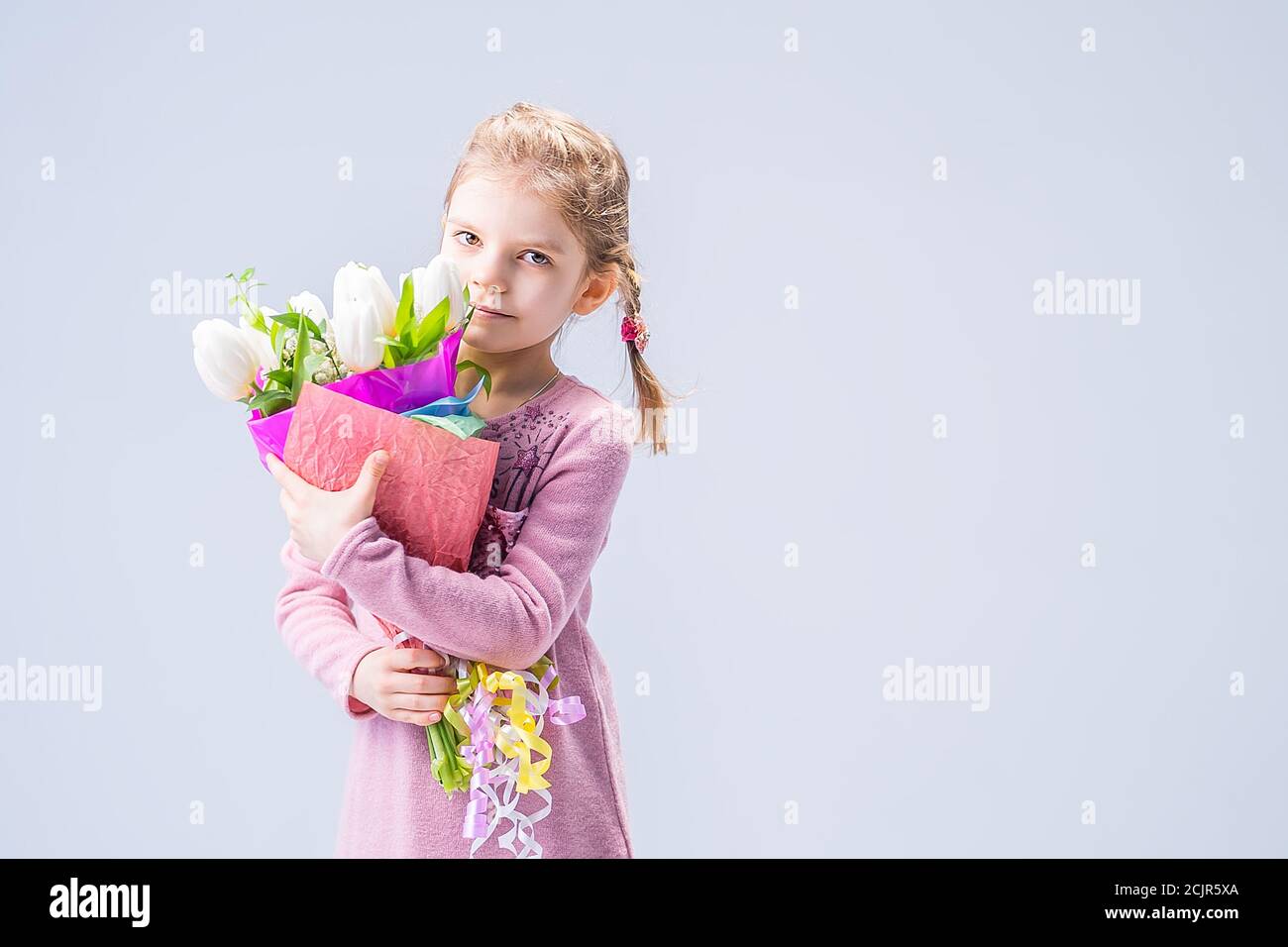beautiful little girl with a bouquet of white tulips Stock Photo - Alamy
