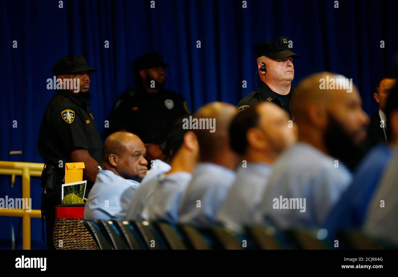 Prisoners and correctional officers listen as Pope Francis meets with
