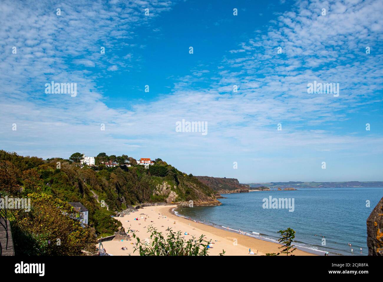 Tenby North beach sandy beach with the pinnacle of Goskar rock sticking out of the sand in the middle. Stock Photo