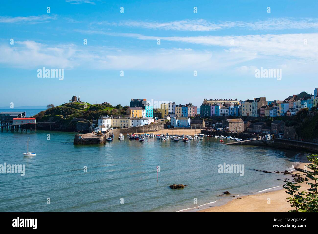Tenby North beach sandy beach with the pinnacle of Goskar rock sticking out of the sand in the middle. Stock Photo