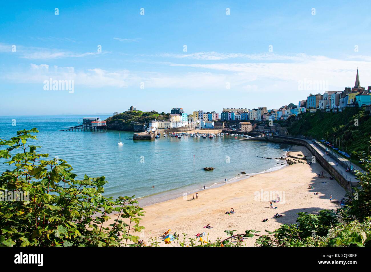 Tenby North beach sandy beach with the pinnacle of Goskar rock sticking out of the sand in the middle. Stock Photo