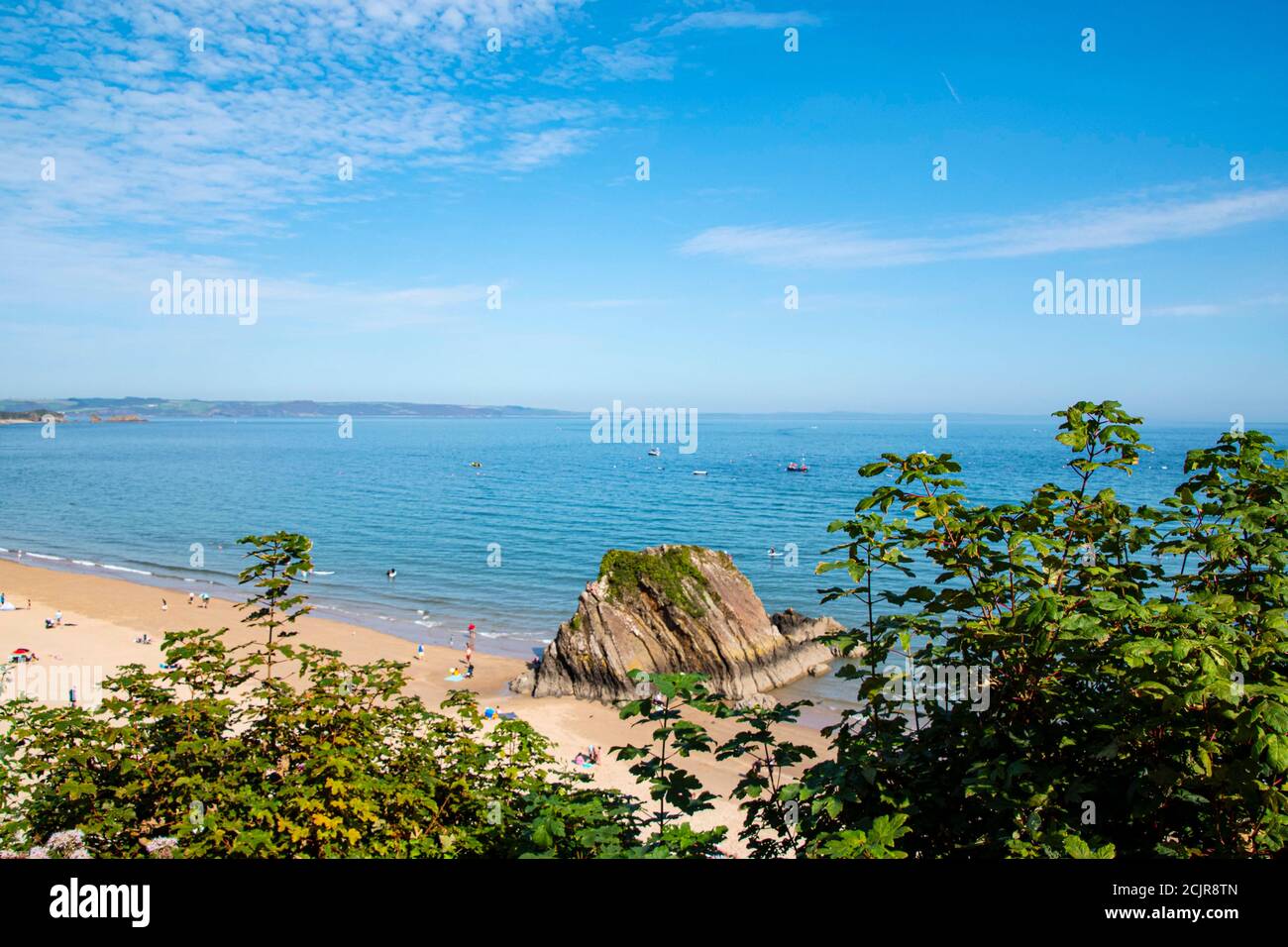 Tenby North beach sandy beach with the pinnacle of Goskar rock sticking out of the sand in the middle. Stock Photo