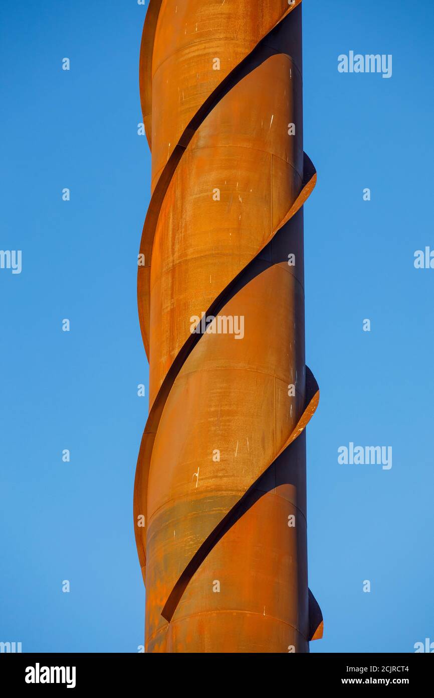 Vortex shedding damper structure against wind induced vibrations on a rusty steel chimney , Finland Stock Photo