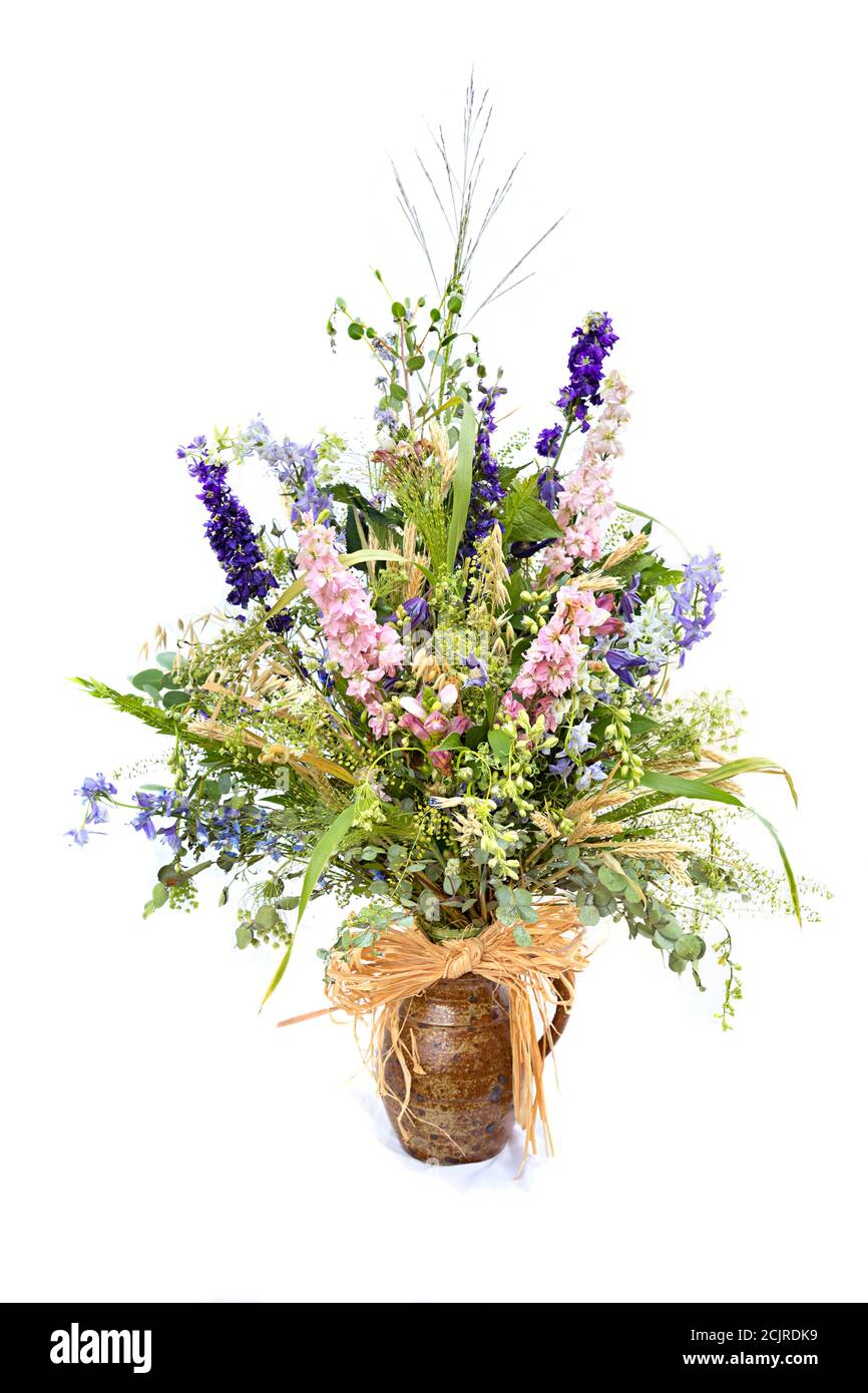Cut flowers in pottery jug spray of natural flowers and grasses, UK Stock Photo