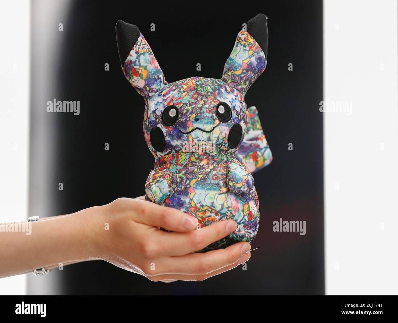 A Sales Personnel Shows Off A Limited Graffiti Version Pikachu At Pokemon Center Shibuya At At Shibuya Parco A Department Store And Shopping Mall Complex During A Press Preview In Tokyo Japan