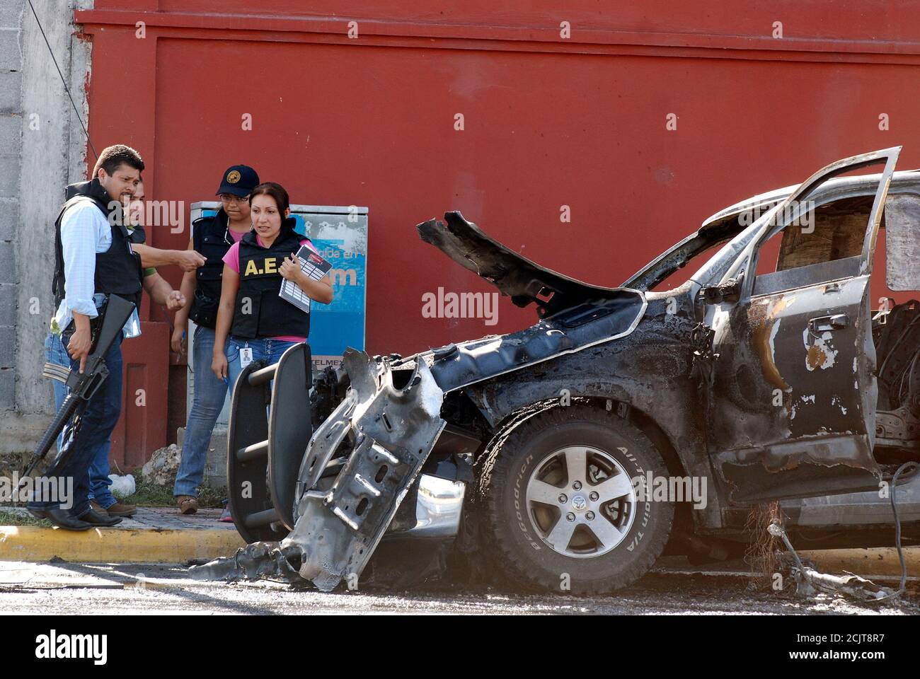 Police Detectives Talk Next To The Burnt Wreckage Of A Pickup Truck That Was Attacked In The Municipality Of Escobedo Neighbouring Monterrey July 27 2011 The Vehicle Assigned To The Bodyguards Of