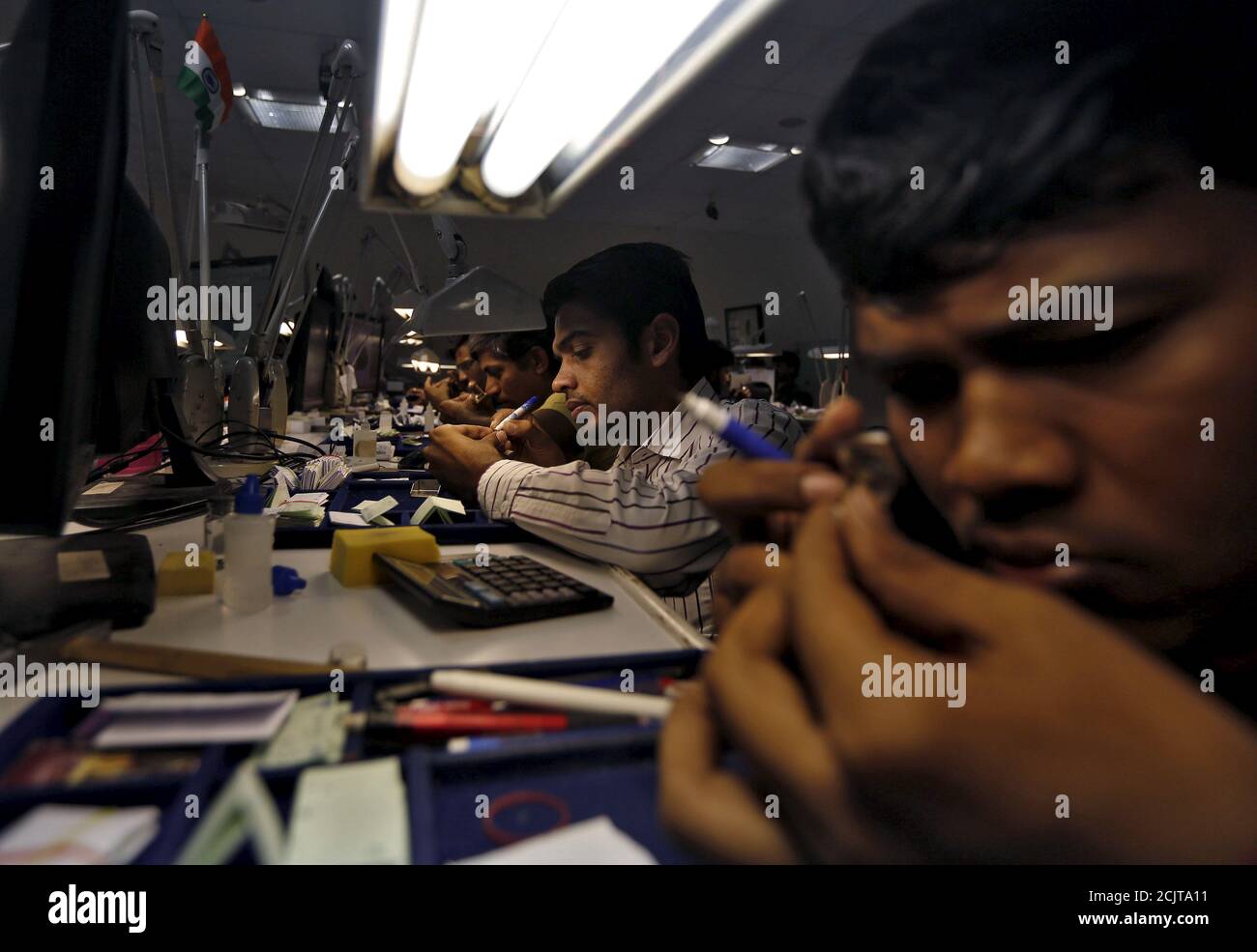 Craftsmen work at the polishing department of a diamond processing unit at Surat in Gujarat, India, August 31, 2015. More than 5,000 Surat polishers have lost their jobs since June and thousands Craftsmen work at the polishing department of a diamond processing unit at Surat in Gujarat, India, August 31, 2015. More than 5,000 Surat polishers have lost their jobs since June and thousands