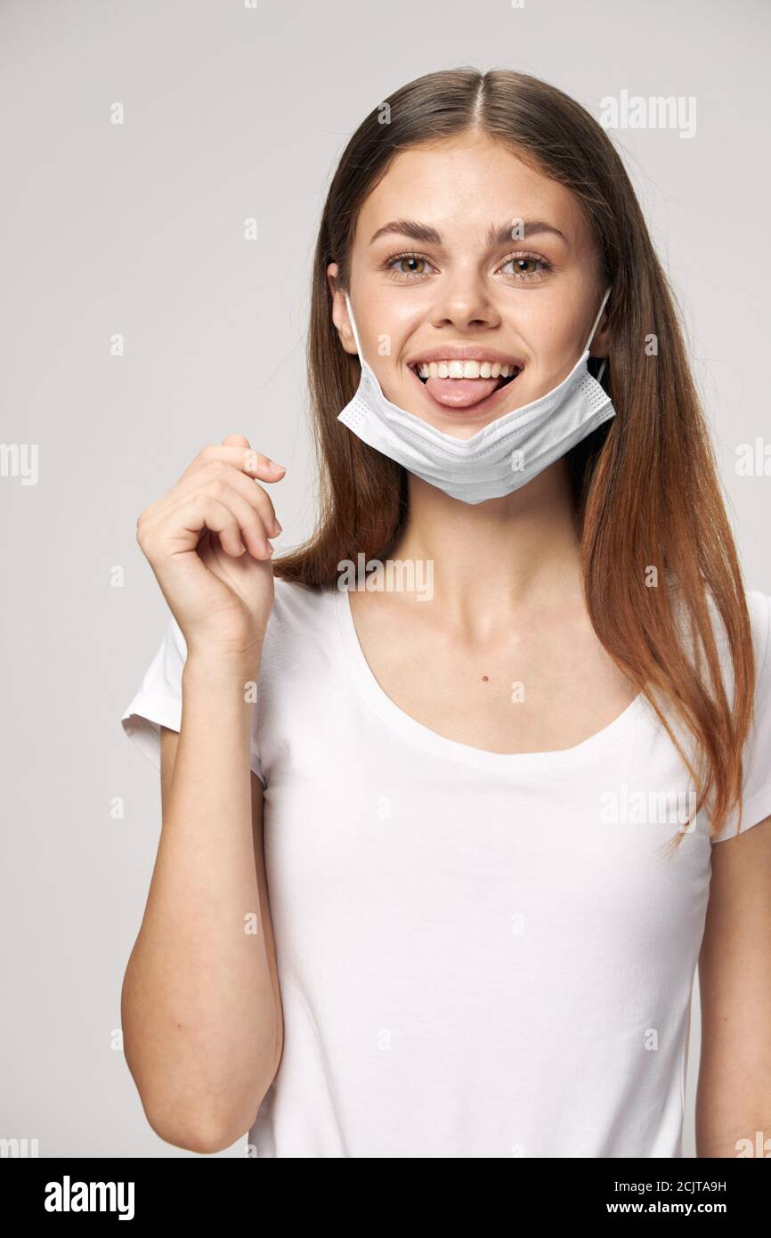 Woman in a medical mask shows tongue Look Forward Stock Photo Alamy