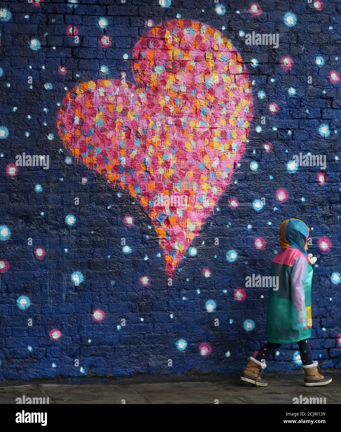 A young girl walks past a mural, by British-born Australian artist James Cochran, painted to commemorate the victims of the London Bridge attack, in London, Britain, April 2, 2018. REUTERS/Hannah McKay Stock Photo