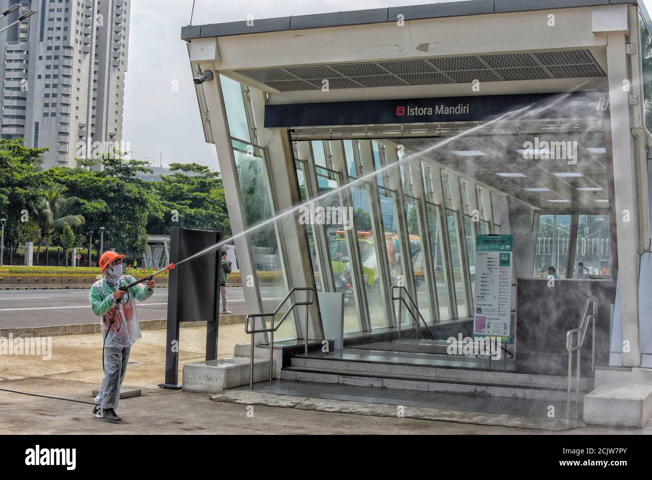 Indonesia, Jakarta - Maret 27, 2020: Jakarta provincial janitor sprays disinfectant liquid in public spaces to prevent the spread of coronavirus Stock Photo