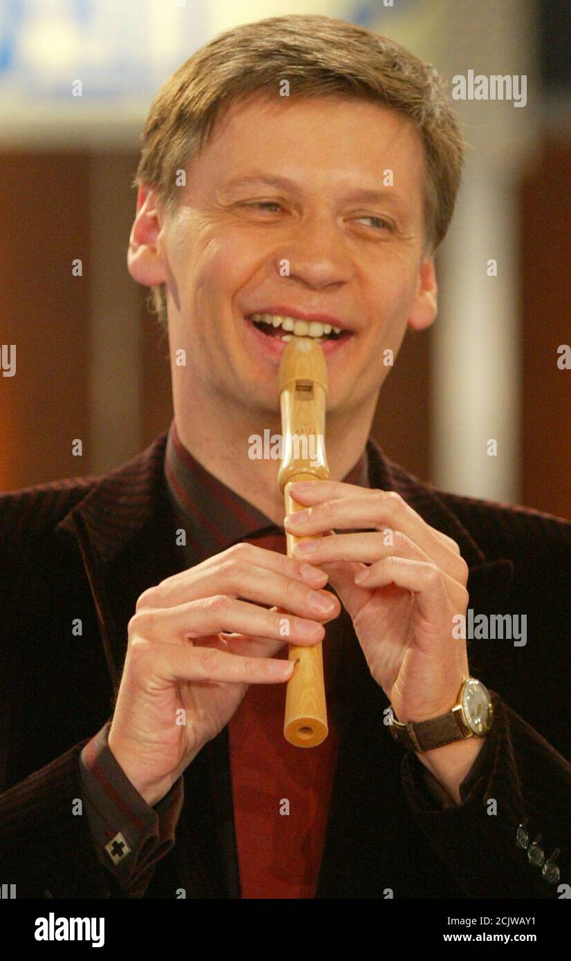 German TV presenter Guenther Jauch plays the flute during the