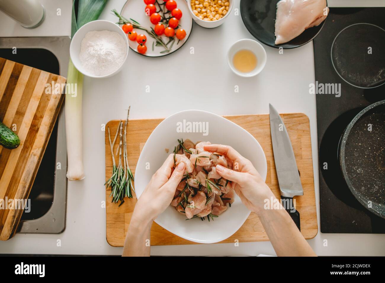 female checking the meet before frying it. tender meat for salad Stock