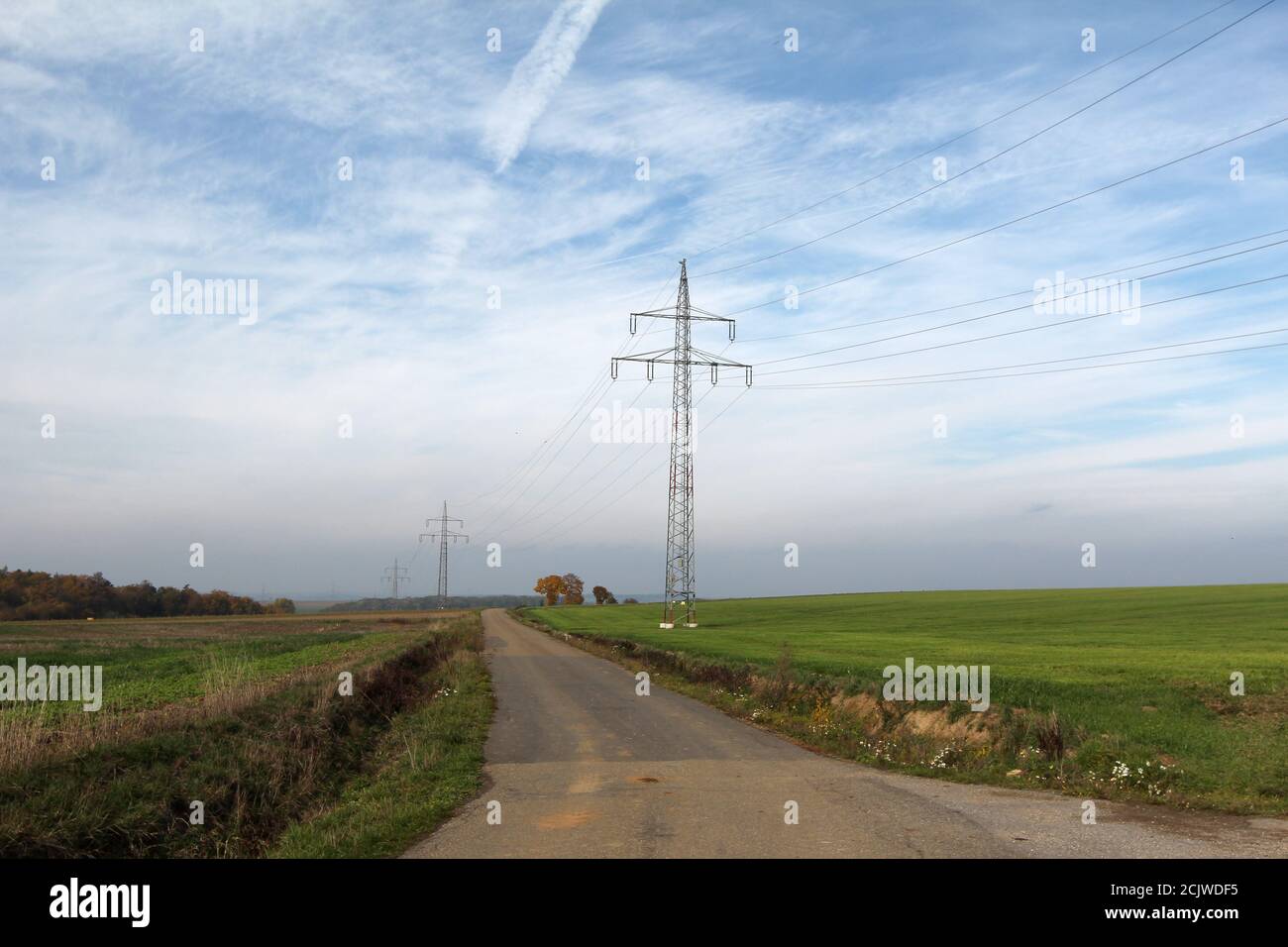 Green field with electric poles with wires Stock Photo - Alamy