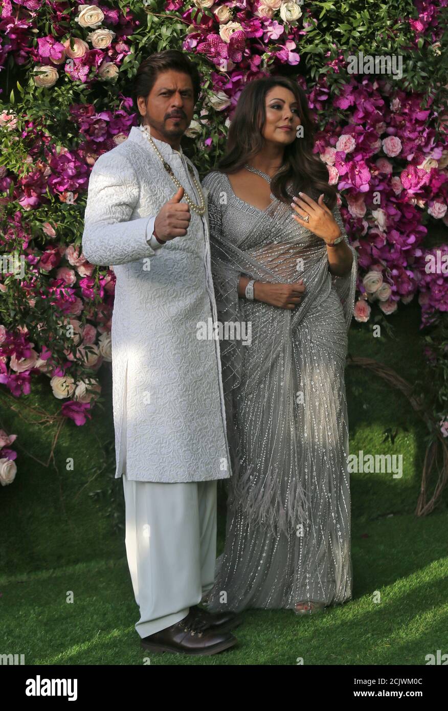Bollywood actor Shah Rukh Khan and his wife Gauri pose during a photo opportunity at the wedding ceremony of Akash Ambani, son of the Chairman of Reliance Industries Mukesh Ambani, at Bandra-Kurla Complex in Mumbai, India, March 9, 2019. REUTERS/Francis Mascarenhas Stock Photo
