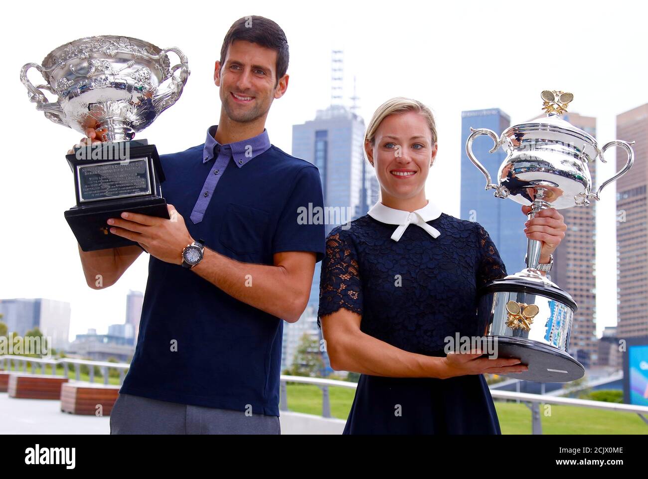Current Australian Open tennis champions Serbia's Novak Djokovic and  Germany's Angelique Kerber stand together as they
