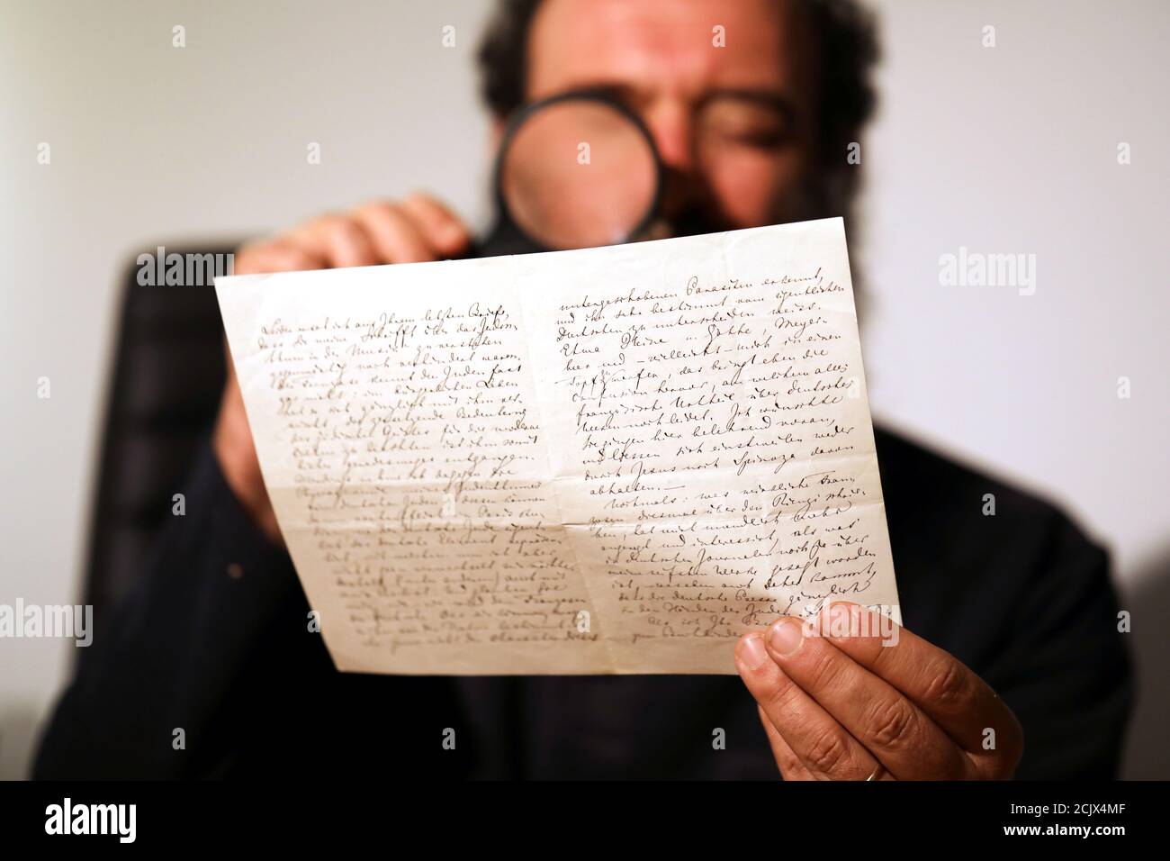 Meron Eren of Kedem Auction House holds a letter handwritten by composer  Richard Wagner in 1869, before it is sold at an auction in Jerusalem, April  24, 2018. REUTERS/Ammar Awad Stock Photo - Alamy