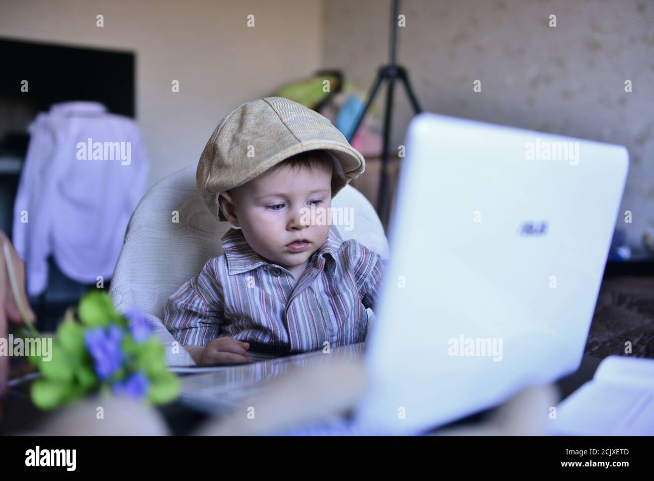 a child in front of a computer is studying or working at home Stock Photo