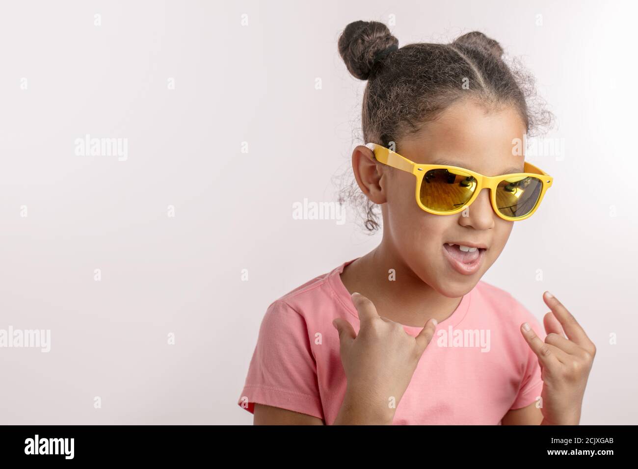 funny awesome girl with open mouth is crazy about rock music. isolated ...