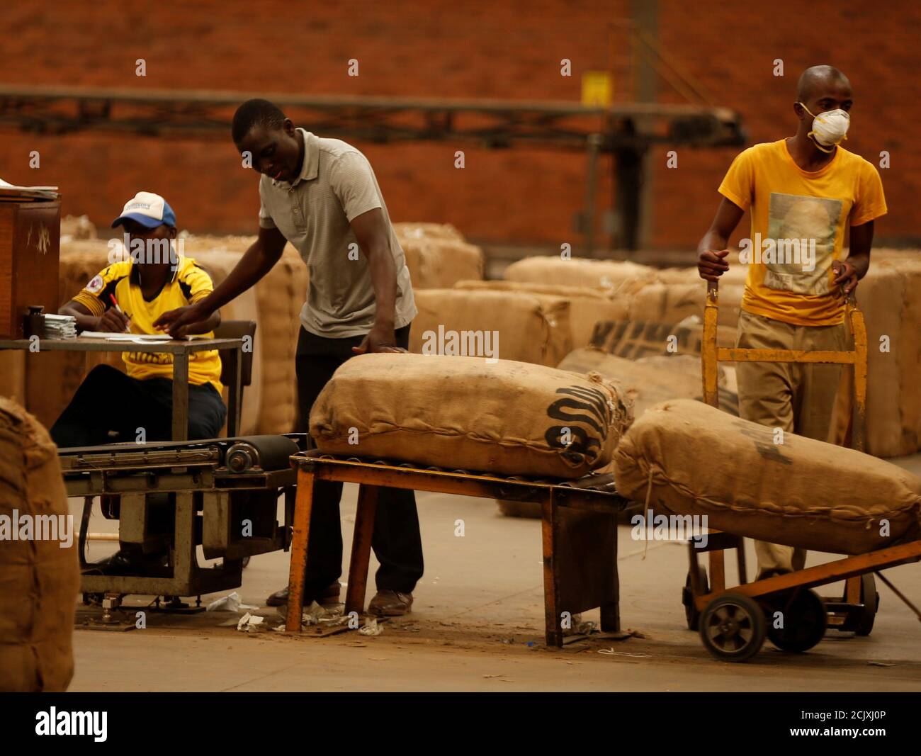 Workers await the start of the marketing season at Tobacco Sales Floor in Harare, Zimbabwe, March 21, 2018. REUTERS/Philimon Bulawayo Stock Photo