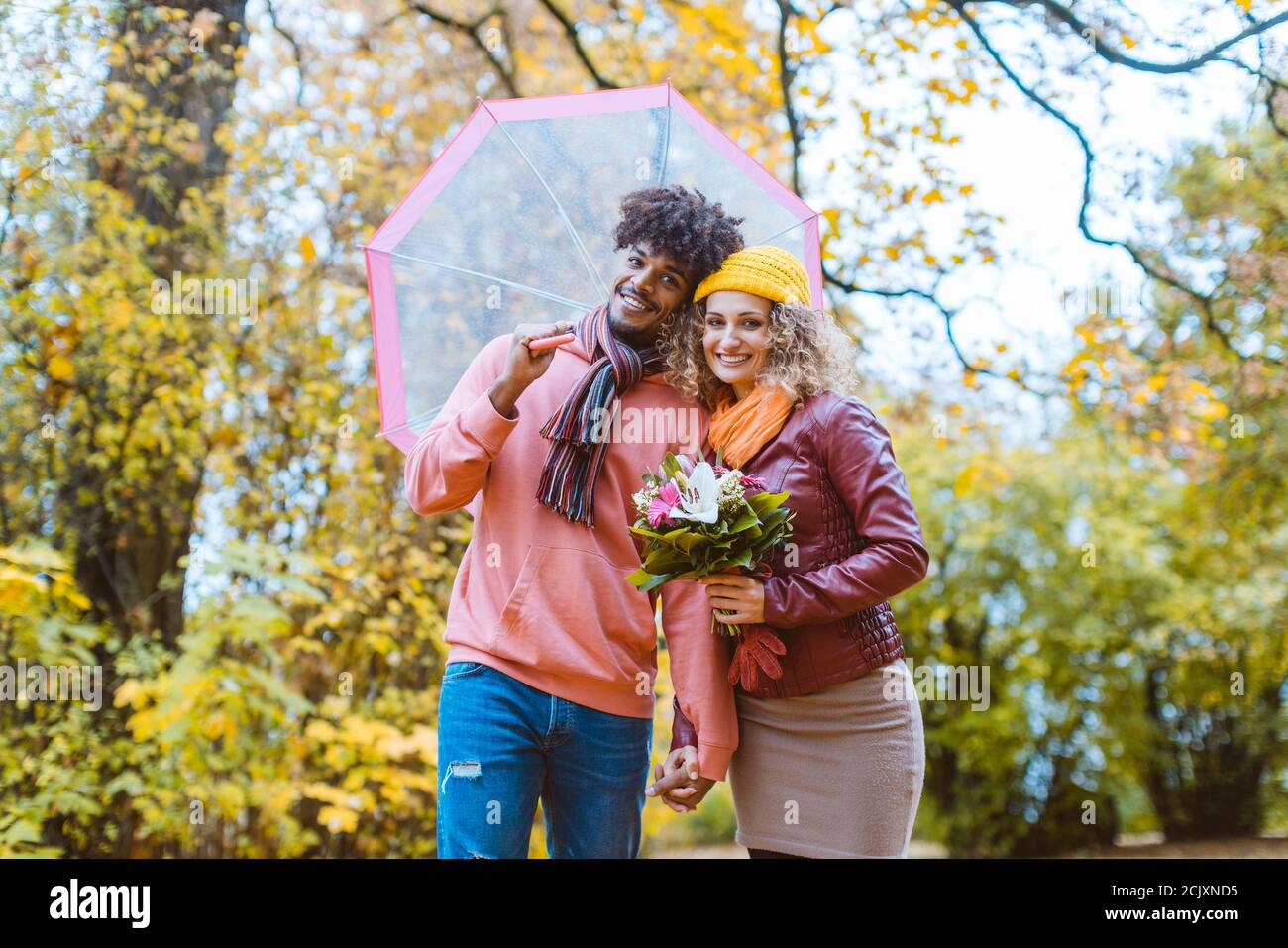 Man and woman of different ethnicity hugging in fall Stock Photo - Alamy