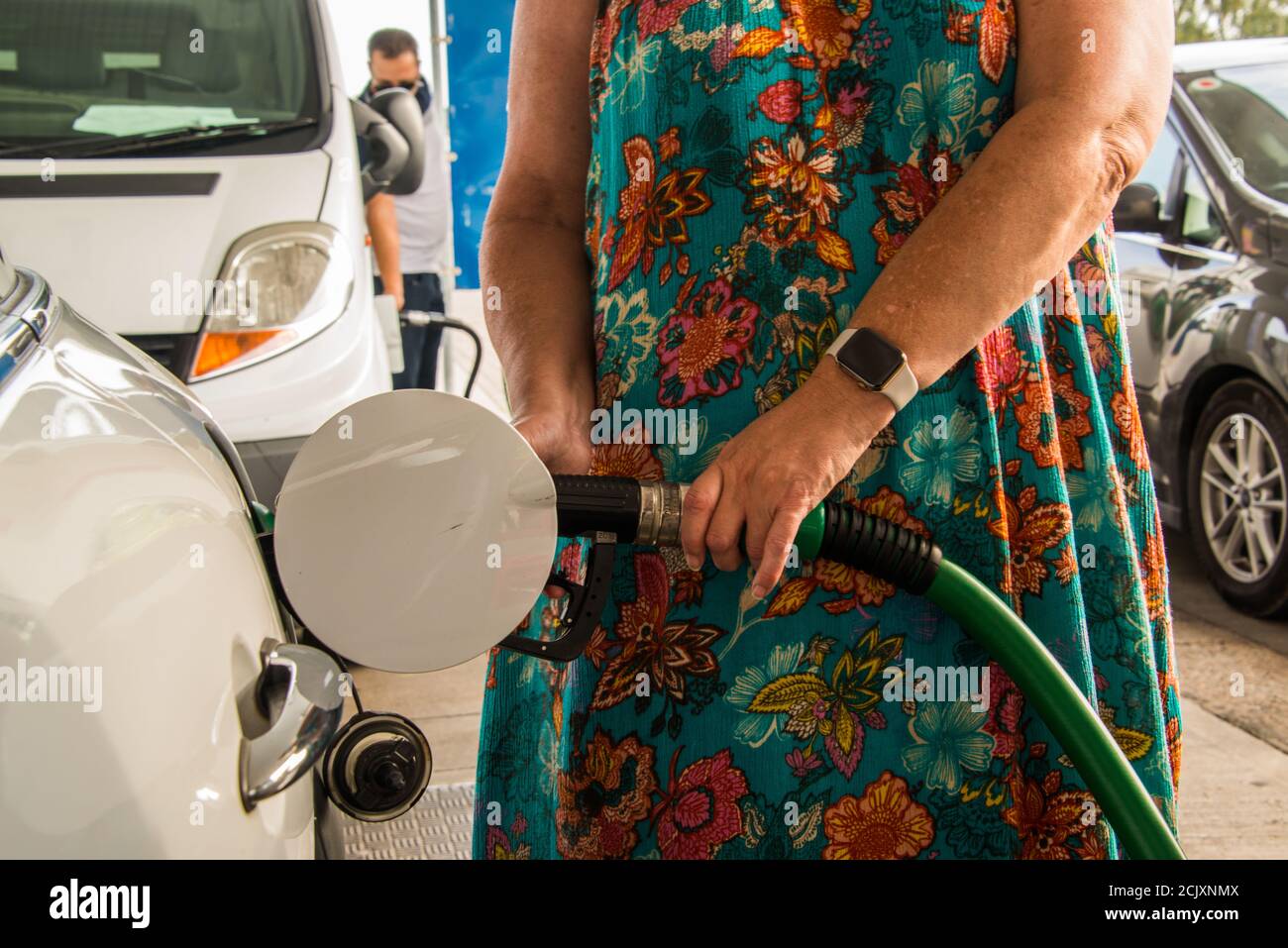 Woman refueling her car. Stock Photo