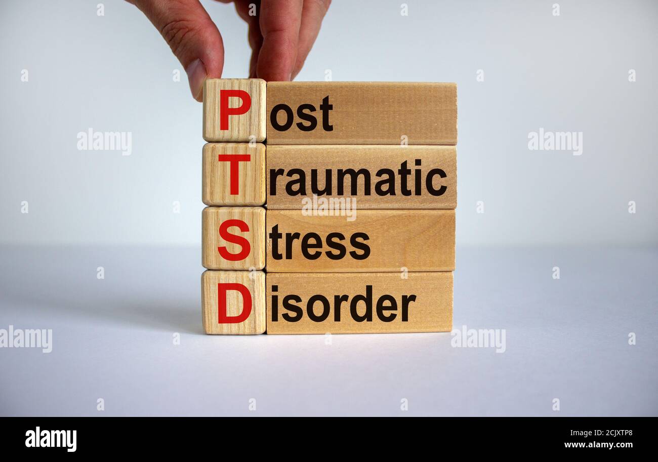 Concept words 'PTSD, post-traumatic stress disorder' on cubes and blocks on a beautiful white background. Copy space. Stock Photo
