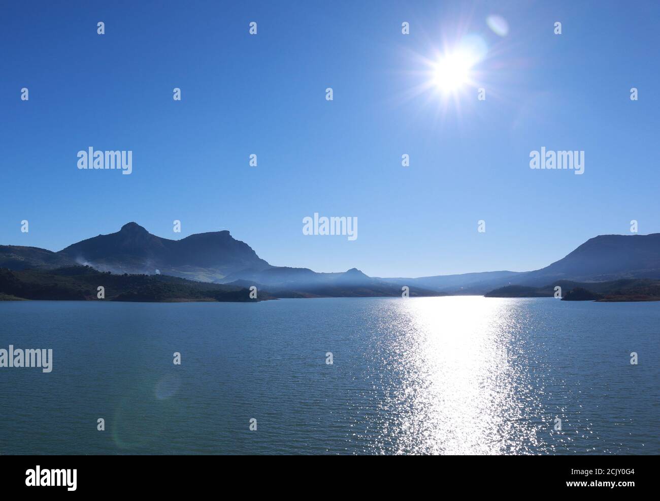 Andalusia, Spain, blue sea view on a hot clear summer day, mountains and landscape with sun flare. Stock Photo