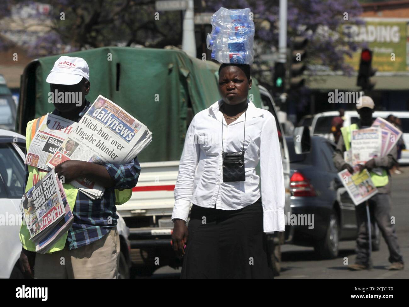 Hawkers sell goods on the streets of Zimbabwe's capital Harare, September 17, 2015. Most Zimbabweans survive through vending and hawking and even the country's police are no exception. As Zimbabwe sheds any veneer of formally regulated commerce, a host of vendor unions claim to represent between 100,000 and 6 million traders, nearly half the nation's 13 million people. Picture taken September 17, 2015 REUTERS/Philimon Bulawayo Stock Photo