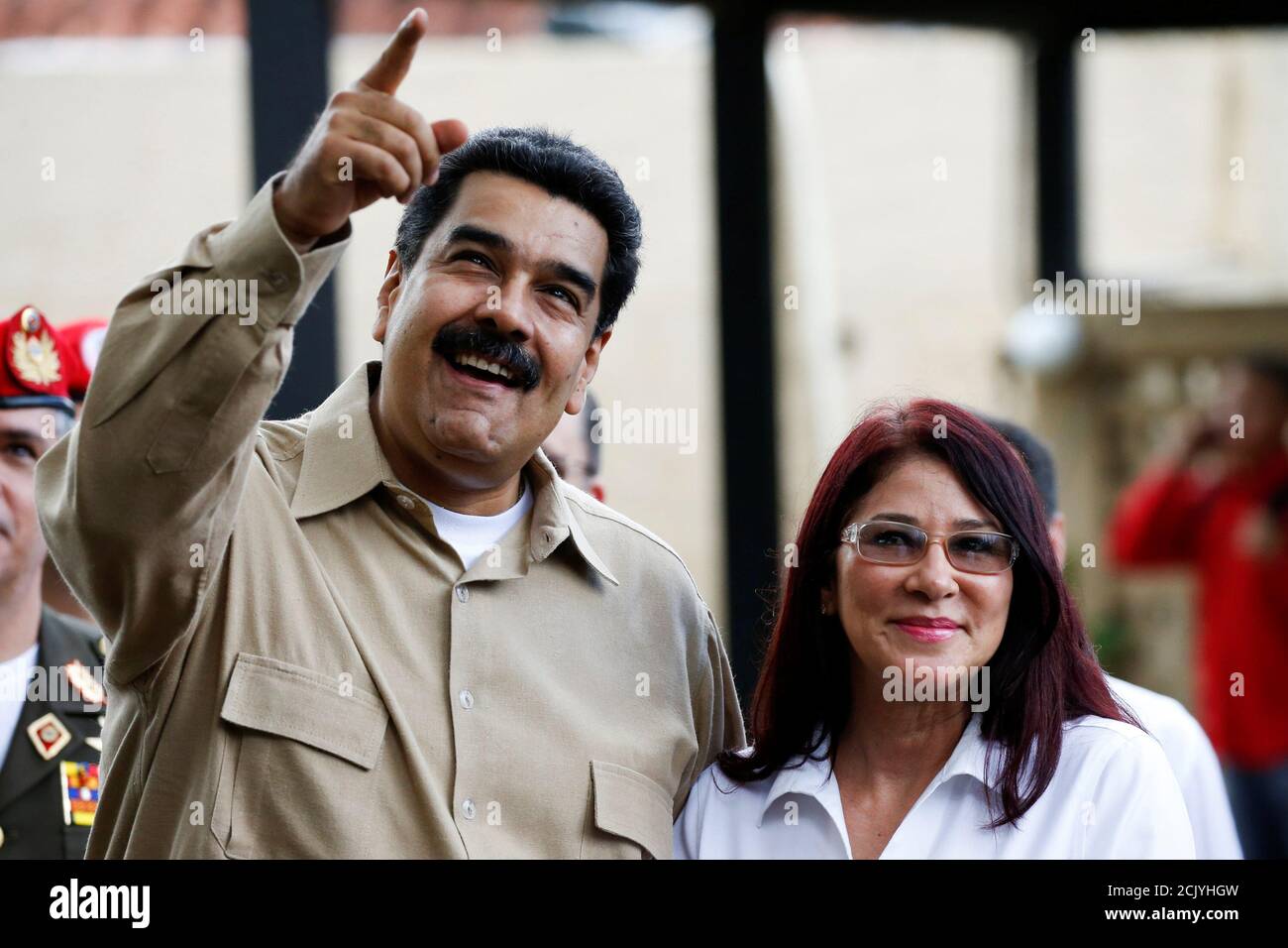 Venezuela's President Nicolas Maduro (L) talks to his wife Cilia Flores  while they wait the arrival of Colombia's President Juan Manuel Santos at  Macagua Hydroelectric compound in Puerto Ordaz, Venezuela August 11,