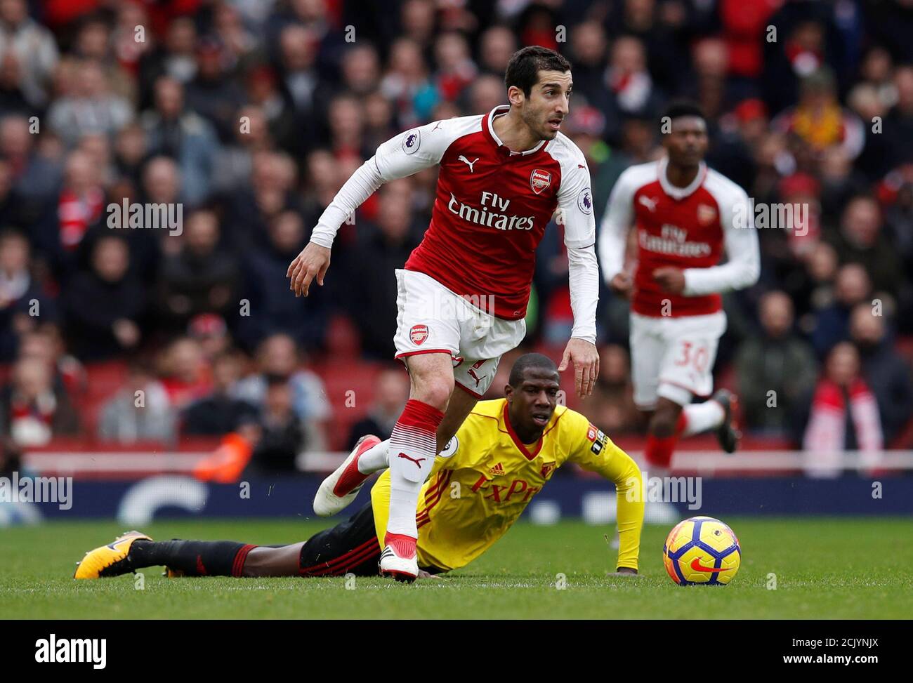 Soccer Football - Premier League - Arsenal vs Watford - Emirates Stadium, London, Britain - March 11, 2018 Arsenal's Henrikh Mkhitaryan in action with Watford's Abdoulaye Doucoure REUTERS/Eddie Keogh EDITORIAL USE ONLY. No use with unauthorized audio, video, data, fixture lists, club/league logos or "live" services. Online in-match use limited to 75 images, no video emulation. No use in betting, games or single club/league/player publications. Please contact your account representative for further details. Stock Photo