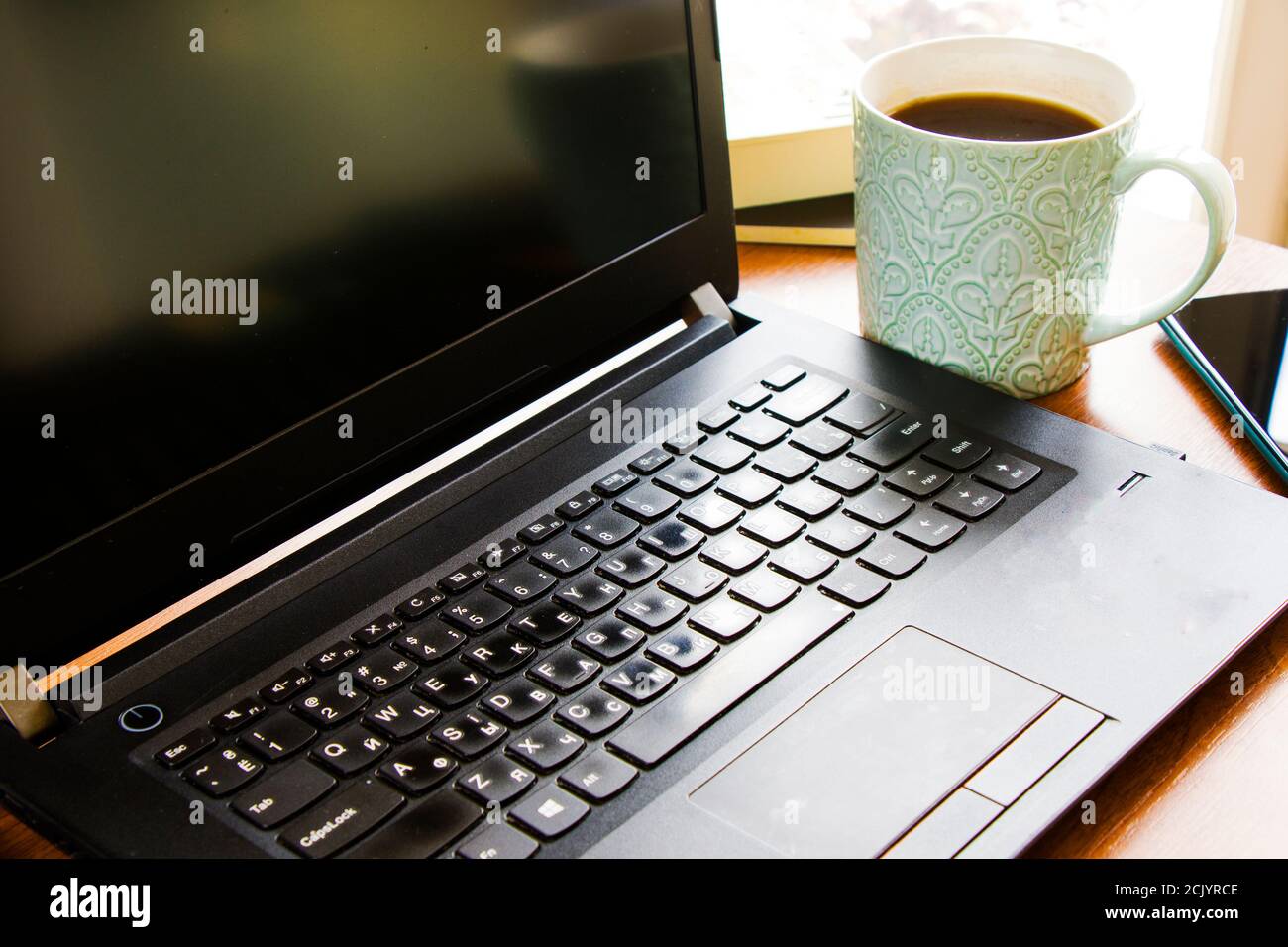 Workspace at home, notebook, mobile device, coffee and plants on the ...