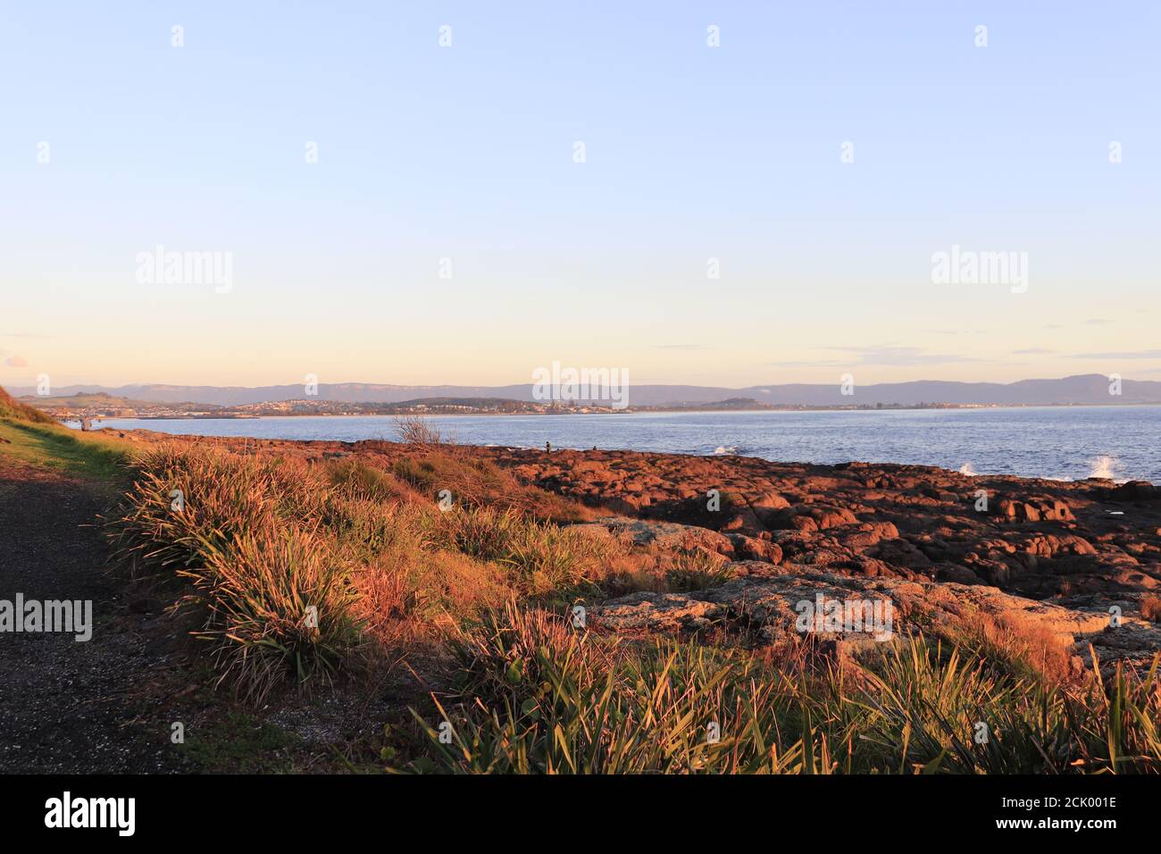 Beautiful shot of a rocky seashore with an ocean at sunset Stock Photo ...