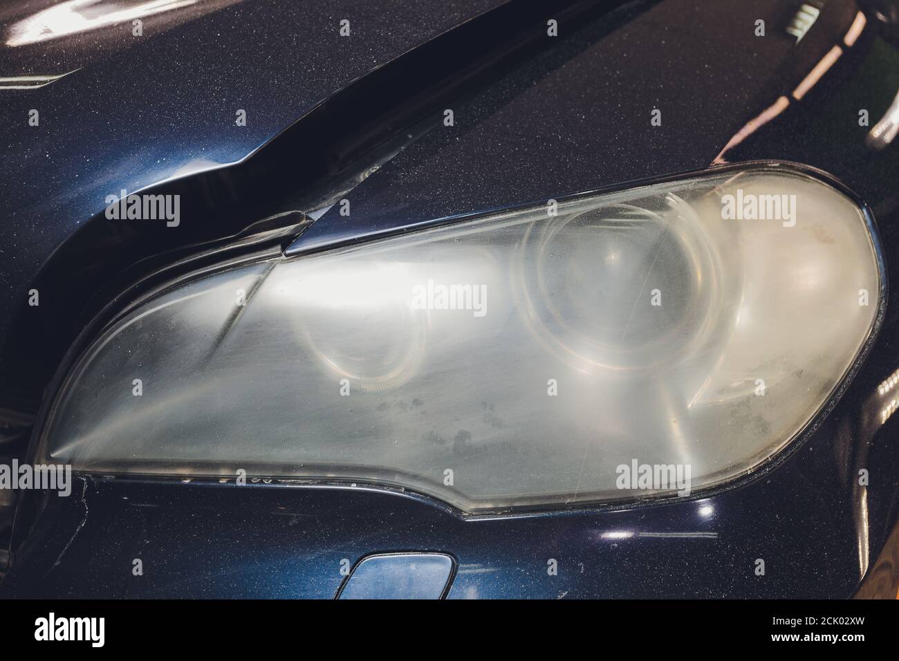 Car headlights cleaning with power buffer machine at car service Stock