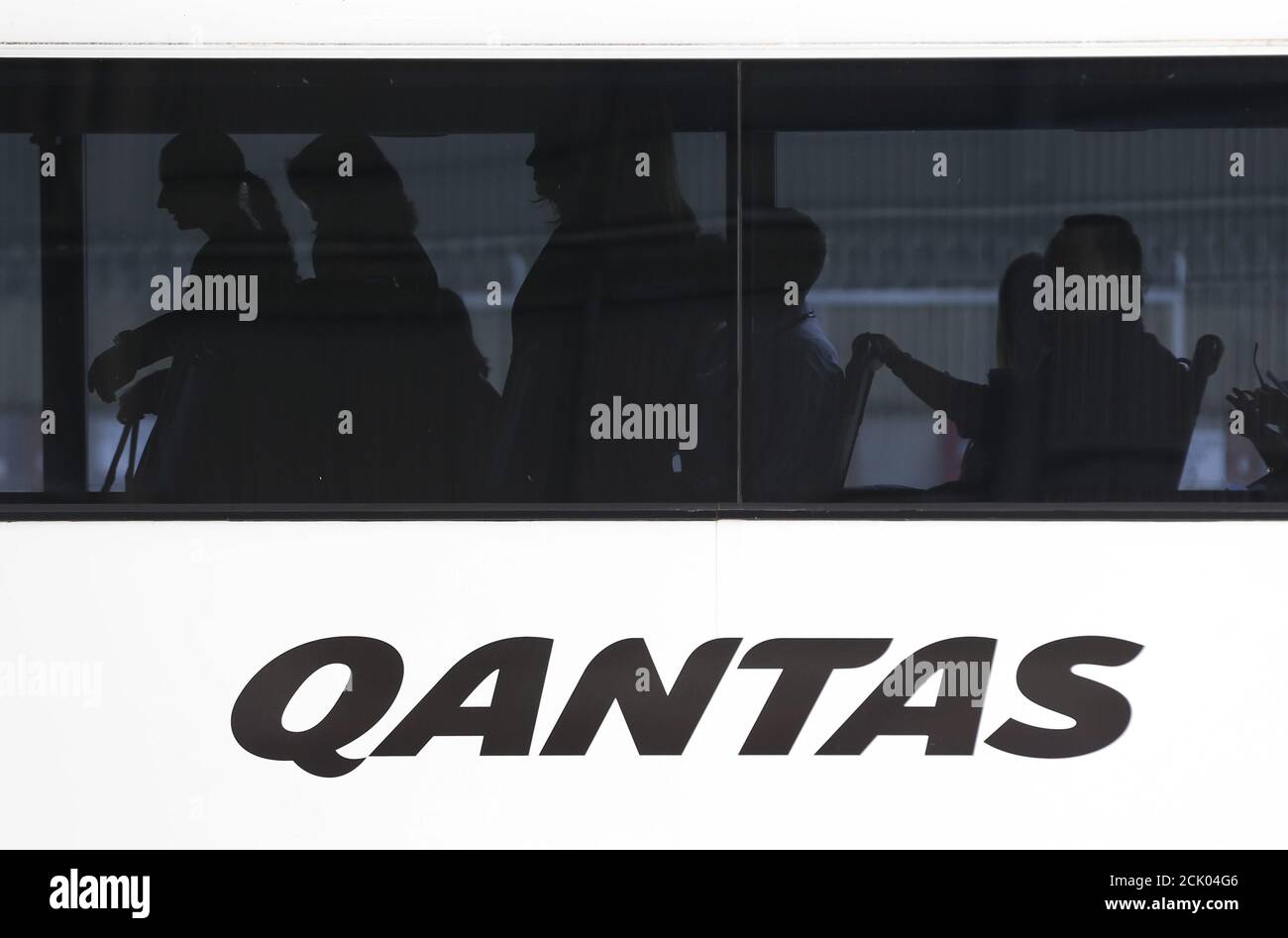 Staff of Qantas airlines are pictured on a company bus at they arrive at a hangar during an event marking the 95th anniversary of the Airline, at Sydney International Airport, November 16, 2015.   REUTERS/Jason Reed Stock Photo